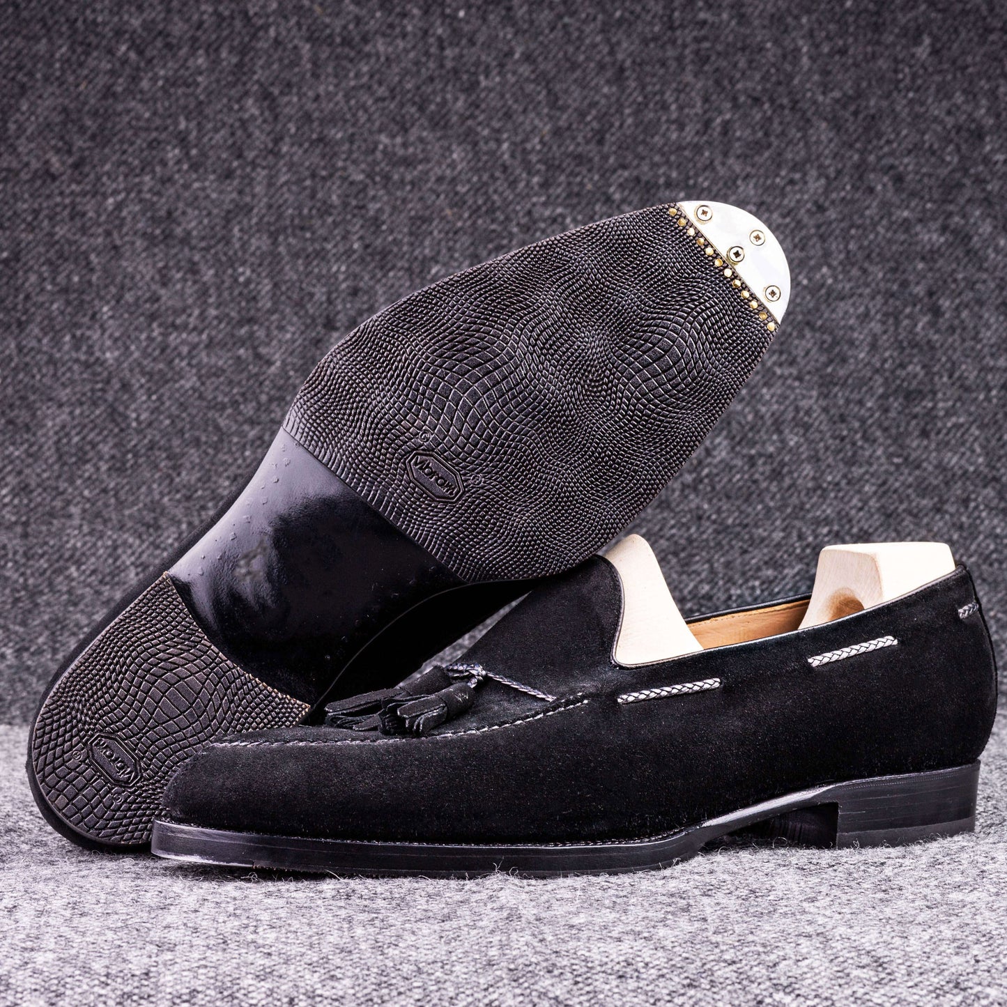 Tassel loafer with hand stitched apron in black suede